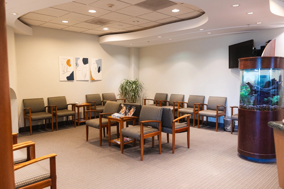 Modern orthodontic waiting room with comfortable seating, plants, and welcoming décor.
